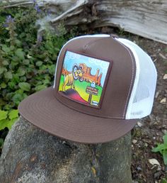 In the desert, magic is everywhere and Henry finds it for you with wonderful painting reproduced on this trucker hat. Featuring a flat bill and one size fits most, this mesh back snap back cap is for you. Fits even most larger head sizes. Cheap Urban Flat Bill Hats, Summer Flat Bill Snapback Hat, Gold Leaf Bill Hat, Desert Magic, White Trucker Hat, Snap Back Cap, Country Hats, Flat Bill Hats, Snap Back