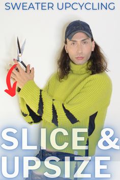 a man in a green sweater holding scissors and pointing to the side with his right hand