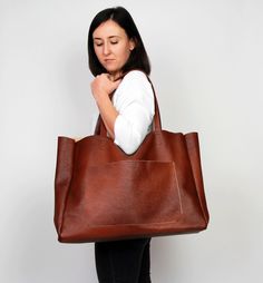 "Cognac brown leather tote - large leather tote bag This brown large tote bag is made from high quality italian leather. Spacious interior provides room for all the daily essentials and more. There is an inside zippered pocket. This bag is perfect as your everyday bag, which can fit an IPAD, A4 files, books, magazines, cosmetic bag as well as many accessories. Additional large slip pocket at the front of the bag. Height: 39 cm / 15.4\" Max width at the top: 61 cm / 24\" Width at the base: 51 cm Large Brown Satchel For Daily Use, Large Brown Rectangular Satchel, Large Rectangular Brown Satchel, Brown Tote Weekender Bag For Everyday Use, Brown Large Capacity Weekender Bag For Everyday, Cognac Large Capacity Weekender Bag, Large Brown Double Handle Satchel, Everyday Large Brown Satchel, Brown Large Satchel For Everyday Use