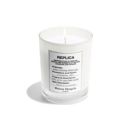 a candle that is sitting on a white surface with the words replicaca printed on it