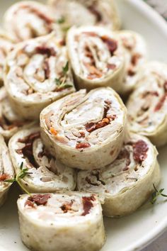 a white plate topped with rolls covered in meat