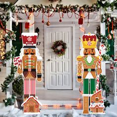 christmas decorations are displayed in front of a house decorated with gingerbreads and nutcrackers