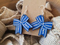 PERSONALIZED CHEERLEADER BOW  EARRINGS  Cheer Mom Materials: Wood 3mm thick Paint Engraved on both sides Sterling silver hooks  Dimensions: 1.5" diameter  All of our earrings are made to order with love and care in our Florida shop  HOW TO ORDER Please choose your wood color and enter your cheerleaders name and team in the PERSONALIZATION  section Cheerleader Earrings, Cheer Earrings, Sports Earrings, Cheer Coach Gifts, Cheerleading Bows, Thick Paint, Cheer Coach, Pom Pom Girl, Cheer Coaches