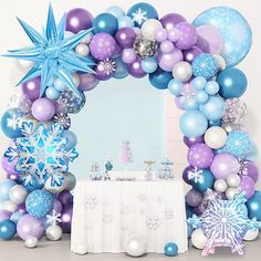 an arch made out of balloons and snowflakes