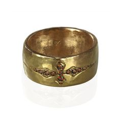 a gold ring with a cross on it