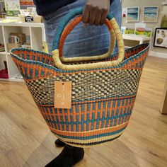 a person holding a woven basket in their hand