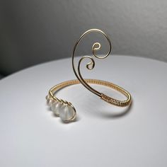 Wrist Cuff Gold Asymmetrical Swirly Design Glass Beads Arm Band Wire Wrapped Adjustable Minimalist Bracelet - Etsy Elegant Spiral Hand Wrapped Jewelry, Modern Adjustable Beaded Bracelets For Party, Adjustable Metal Bangle With A Modern Twist, Elegant Beaded Spiral Jewelry, Elegant Spiral Adjustable Bangle, Adjustable Modern Twist Bracelet, Elegant Spiral Metal Bangle, Elegant Spiral Metal Cuff Bracelet, Elegant Metal Spiral Cuff Bracelet