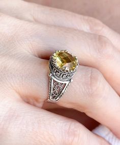 "This everyday use, lace embroidery minimalist sterling 925 sterling silver filigree art crown cocktail ring has citrine gemstone. The ring face is 0.47\" / 12.00 mm. Citrine gemstone is 10 mm, double side faceted, checkerboard round-cut. It takes its name from the citron fruit because of these lemon-inspired shades. Citrine is the traditional birthstone for November, and is an alternate Zodiac stone for Scorpio. This yellow stone, filigree art, dainty ring would make the perfect option for a bi Elegant Silver Citrine Jewelry, Elegant Silver Jewelry With Citrine, Exquisite Citrine Rings As A Gift, Yellow Filigree Jewelry Gift, Heirloom Sterling Silver Filigree Ring As Gift, Sterling Silver Filigree Ring With Gemstone For Gift, Gold Sterling Silver Filigree Ring With Gemstone, Topaz Rings With Intricate Design For Gift, Exquisite Gemstone Filigree Ring As A Gift