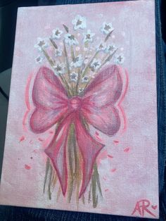 a painting of a pink bow with white flowers