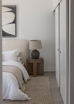 a bedroom with white walls and neutral decor