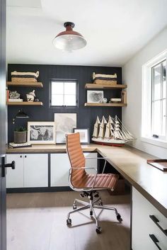 a home office with shelves, desk and chair in it's center area is shown