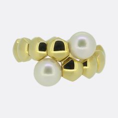 This is an 18ct yellow gold diamond ring from the world renowned luxury designer Piaget. The ring features two cultured pearls that sit on the end of the crossover band. Condition: Used (Very Good) Weight: 12.3 grams Ring Size: P (56) Band Width: 6.5mm - 14mm Pearls: 2 (7.3mm) Marked: 'Piaget' '750' '56' '1997' and the serial number Box: Plain gift box If you have any questions regarding my items, just send me a message and I will get back to you as soon as I can.  Check out my shop to see my ra Modern Yellow Gold Pearl Ring For Anniversary, Modern Yellow Gold Pearl Ring For Formal Occasions, Modern Round Pearl Ring In Yellow Gold, Formal Yellow Gold Akoya Pearl Ring, Luxury Gold Akoya Pearl Ring, Luxury Akoya Pearl Ring In Yellow Gold, Formal Gold Rings With Akoya Pearl, Luxury Yellow Gold Akoya Pearl Rings, Crossover Ring