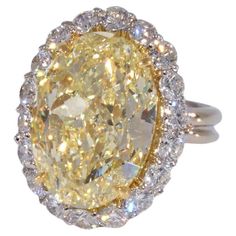 an oval yellow diamond surrounded by white diamonds