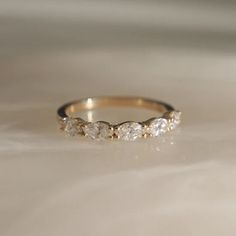 a diamond ring sitting on top of a white table next to a light colored wall