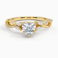 a yellow gold ring with a heart shaped diamond