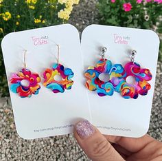 Colorful Groovy Flower Earrings. Crafted from high-quality patterned acrylic, these earrings are wonderfully lightweight. Choose from two sizes: Small, with a 1" diameter flower, or Large, with a 1.25" diameter flower. Designed for comfort, these earrings feature hypoallergenic stainless steel findings, making them gentle on even the most sensitive ears. Their lightweight construction ensures you can wear them joyfully throughout the day, effortlessly adding a touch of flair to any outfit withou Trendy Multicolor Flower Earrings, Playful Handmade Multicolor Flower Earrings, Playful Multicolor Handmade Flower Earrings, Summer Multicolor Earrings With Flower Charm, Trendy Multicolor Flower Earrings For Spring, Trendy Summer Flower Earrings, Playful Multicolor Flower Earrings As Gift, Colorful Earrings As Spring Gift, Colorful Spring Gift Earrings