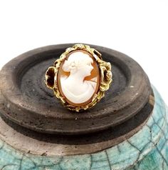 ANTIQUE CAMEO RING, 10K Yellow Gold, Floral Poppy Flower Setting, Circa 1950, Size 7, By E. S. Feinstein & Co.. Magnificent setting on this vintage Cameo ring. Art nouveau style of poppy flowers and leaves. It really makes the ring. Hallmarked 10K, Engraved inside of band, G.H.W. TO M.R.W., 1950. Measures a US size 7. Top setting measures about 3/4' x 3/4". Weighs 5.1 grams. Has an F makers mark within a triangle cartouche for the maker E.S. Feinstein & Co. based in New York, NY. Excelle Vintage 14k Gold Cameo Rings, Vintage Yellow Gold Cameo Rings, Vintage Intaglio Jewelry For Anniversary, Gold Cameo Rings For Anniversary, Vintage Gold Cameo Ring, Yellow Gold Cameo Jewelry For Anniversary, Flower Setting, Heirloom Rings, Gold Amethyst Ring