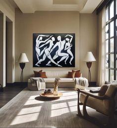 a living room filled with furniture and a painting on the wall