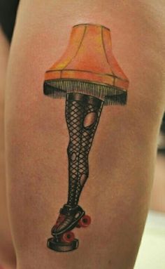 a woman's thigh with a lamp on it and roller skates underneath her leg