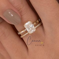 a woman's hand with a diamond ring on top of her finger and an engagement band