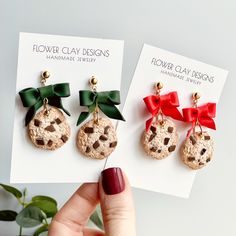 three different earrings with bows on them are shown in front of a card that says flower clay designs