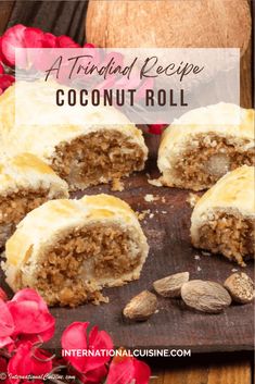 coconut roll cut in half on top of a wooden cutting board with flowers around it