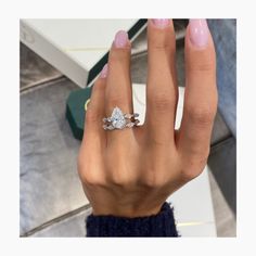 a woman's hand with a diamond ring on it