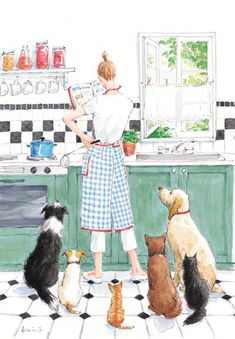 a woman is cooking in the kitchen with her four dogs looking at something on the counter