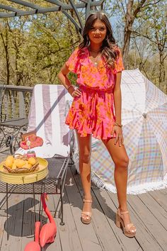 You are guaranteed to look sassy and sweet in this darling hot pink romper featuring lightweight material patterned with a pretty orange floral print, a faux wrap bodice with a v-cut neckline, short loose sleeves, a cinched elastic waistline with a tie closure, a keyhole accented upper back with a button closure, and a relaxed shorts silhouette that ends in straight upper-thigh length hemlines! on products Measurements XS : Bust 30", Hip 32", Inseam 2", Length 30", Sleeve Length 7", Waist 28". S : Bust 32", Hip 34", Inseam 2", Length 31", Sleeve Length 7", Waist 30". M : Bust 34", Hip 36", Inseam 2", Length 32", Sleeve Length 7.5", Waist 32". L : Bust 36", Hip 38", Inseam 2", Length 33", Sleeve Length 7.5", Waist 34". XL : Bust 38", Hip 40", Inseam 2.5", Length 34", Sleeve Length 8", Waist Beach Jumpsuits And Rompers With Surplice Neckline For Spring, Spring Beach Jumpsuits With Surplice Neckline, Pink Summer Jumpsuits And Rompers For Brunch, Pink Jumpsuits And Rompers For Summer Brunch, Summer Pink Floral Jumpsuits And Rompers, Summer Pink Floral Print Jumpsuits And Rompers, Summer Floral Print Pink Jumpsuit, Summer Pink Floral Print Jumpsuit, Pink Jumpsuits And Rompers For Spring Vacation