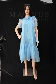 Step into effortless elegance with our Women's Blue Organza Midi Dress. This stunning organza dress captures the essence of summer fashion, perfect for special occasions or casual outings. Key Features: - Luxurious blue organza fabric for a delicate look - Flattering midi length that suits all body types - Lightweight and breathable, ideal for warm weather - Available in sizes XS to XL with customization options Crafted with care, this dress is not just a stylish choice; it's a sustainable one t Silk Chiffon Summer Dress, Chic Knee-length Chiffon Summer Dress, Casual Blue Chiffon Summer Dress, Sheer Organza Short Sleeve Dress, Sheer Organza Dress With Short Sleeves, Sheer Blue Summer Dress, Elegant Organza Day Dress, Elegant Organza Daywear Dress, Elegant Daywear Organza Dresses