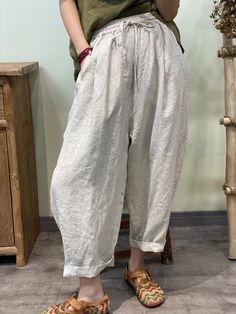 Stay cool and stylish in our Summer Solid 100% Linen Harem Pants. Crafted from breathable linen fabric, these pants offer a relaxed fit and effortless summer style. Perfect for casual outings or lounging at home, their versatile design ensures comfort without compromising on fashion. Casual Baggy Wide Leg Pants For Summer, Spring Loungewear Harem Pants With Side Pockets, Relaxed Cotton Harem Pants With Straight Leg, Spring Side Pockets Harem Pants For Loungewear, Spring Harem Pants With Side Pockets For Loungewear, Comfortable White Baggy Bottoms, Comfortable Solid Color Spring Harem Pants, Comfortable Solid Color Harem Pants For Spring, Solid Relaxed Fit Harem Pants For Beach