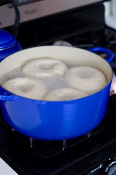 a blue pot filled with food sitting on top of a stove