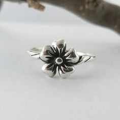 This Adorable Flower ring has been created in solid Sterling Silver and has been patinated to show the detail in the ring and then buffed to a sheen to show the highlights on the petals. The ring is a 3D design that sits slightly above the soldered band. The flower measures 9mm or Silver Flower Ring, Promise Ring Gift, 10 Year Anniversary, Buffalo Ny, Flower Ring, Stackable Rings, Year Anniversary, 3d Design, Floral Rings