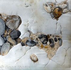 rocks and gravel are embedded into the surface of an old, peeling paint covered wall