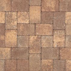 a close up view of a brick floor with brown and tan tiles on the top