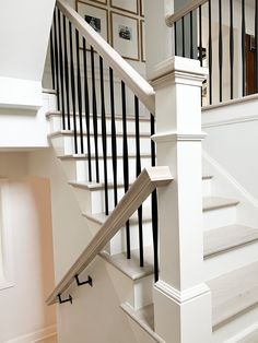 Balusters are the decorative vertical members of a balustrade system. Our ornamental iron balusters offer an extensive assortment of popular styles in various square and round sizes ranging from 1/2-in up to 3/4-in. They are constructed from "mild" steel, making them very durable and much stronger than wrought iron versions. Each and every baluster is handmade, which means no two are exactly alike; the slight variations in the details add exceptional character to any stairway. Our iron balusters Stair Railing In Living Room, Diy Staircase Remodel, Transitional Railings For Stairs, White Stair Railing Ideas, White Railing With Black Spindles, Metal Stair Railing Ideas, Ranch Staircase, Iron Balusters Stairs, Rod Iron Stair Railing