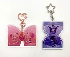 two key chains with tags attached to them on a white surface, one is pink and the other is purple