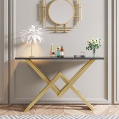 a white table with gold accents and a round mirror on the wall in front of it