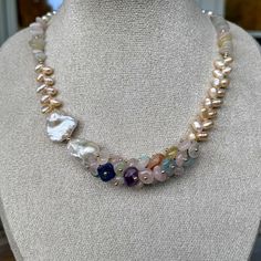 Discover the timeless beauty of our Elegant Harmony Gemstone and Pearl Necklace and Bracelet Set, a perfect fusion of sophistication and natural charm. Handcrafted with meticulous attention to detail, this exquisite set features an enchanting blend of freshwater pearls and multi-colored gemstones, creating a versatile and eye-catching addition to any jewelry collection. Details: Material: Freshwater pearls, assorted gemstones, gold-tone beads and clasps Necklace Length: 41 cm Bracelet Length: 19 Spiritual Multi-stone Round Jewelry, Elegant White Jewelry With Stones, Gemstone Round Beads Jewelry Gift For Her, Spiritual Single Strand Round Jewelry, Pearl White Gemstone Jewelry, Elegant Gemstone Beads Jewelry As Gift For Her, Luxury Gemstone Necklaces As A Gift For Her, Elegant Natural Stones Jewelry Gift For Her, Natural Stones Round Necklace For Her