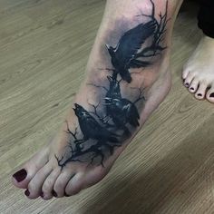 a black and white tattoo on the foot of a person