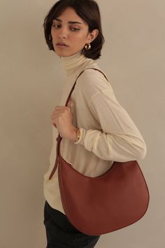 Soft, semi-structured, versatile and perfectly spacious. The classic Hobo shape was redesigned with an adjustable strap in two easy neutrals that will pair with just about everything. Details 12.5" L x 11" H x 4.5" D Zipper Closure ADJUSTABLE STRAP Gold hardware Classic Solid Color Hobo Bag For Daily Use, Classic Everyday Baguette Bag With Adjustable Handle, Classic Baguette Bag With Adjustable Handle For Everyday Use, Classic Everyday Hobo Shoulder Bag, Classic Everyday Hobo Bag For Fall, Classic Hobo Shoulder Bag For Everyday, Classic Hobo Bag For Travel, Timeless Brown Shoulder Bag For Everyday, Timeless Brown Everyday Shoulder Bag