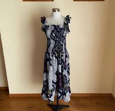 I'm excited to share this super cute dress I whipped up from Japanese Indigo Narumi Shibori Tie-dye Yukata. I've washed and shrunk it already, so it's good to go. Machine wash separately in a cold, gentle setting in a net. Don't bleach. No dryer. Line dry only. I'd give it an 8 out of 10. It's worth adding to your wardrobe! It's an excellent fit on an XS dress form. Your hips must be smaller than 59 inches. The dress's perimeter is 63" without elastic thread, ensuring comfort for individuals with bust sizes between 36" and 42". Please compare the measurements below with those of a similar dress. Measurements (laying flat) (please double where needed) When pulled, the elastic ruffled dress can stretch from 13 1/2 to 21 inches or more. The bottom hem measures 29 inches across, just above the Bohemian Smocked Dress With Ruffled Straps, Bohemian Smocked Dress With Ruffled Straps For Summer, Multicolor Dresses With Smocked Bodice And Ruffled Straps, Bohemian Ruched Spaghetti Strap Dress, Bohemian Spaghetti Strap Ruched Dress, Bohemian Sundress With Ruffle Hem And Ruffled Straps, Bohemian Sundress With Ruffle Hem And Straps, Bohemian Dress With Smocked Bodice And Ruffled Straps, Bohemian Sundress With Ruffled Straps