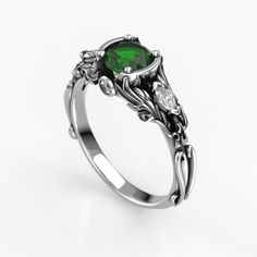 a ring with a green stone in the center