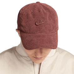 Enjoy a classic look with this Nike Corduroy Club Adjustable Hat. The corduroy fabric adds a touch of vintage flair, while the embroidered Nike Swoosh with raised details on the front panel provides a touch of athletic style. With its adjustable fabric strap and unstructured, relaxed fit, this hat offers a comfortable and customizable fit for all-day wear. Corduroy Cap, Nike Brown, Embroidered Nike, Athletic Style, Fabric Strap, Corduroy Fabric, Nike Swoosh, Athletic Fashion, Vintage Vibes