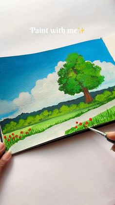 someone is painting a tree with watercolors on the paper and it looks like they are going to paint