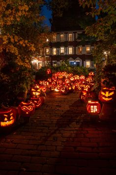 pumpkins lit up in the shape of jack - o'- lanterns at night