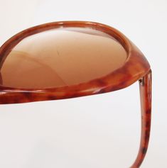 Dating from the late 70s by my estimate, these sunglasses have large gradient brown plastic lenses The frames are marbled opaque plastic in shades of reddish brown. '399 Japan' is barely visible stamped inside one arm. Condition: Just good. I would call the lenses pretty scratched (zoom in to see) and the frames also have some nicks and scratches. Although they do not appear bent at all, when you fold in the arms, they cross rather crookedly (final photo). Still, so cool. Size: The lenses themse Gradient Brown, Plastic Sunglasses, Spokane Wa, Reddish Brown, Pink Mini Dresses, Mirror Table, Made In Japan, Vintage Outfits, Lenses