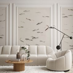 a living room with white furniture and fish wallpaper