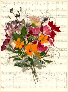 a bouquet of colorful flowers sitting on top of sheet music paper with musical notes in the background