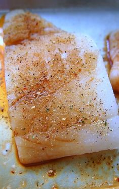 some kind of food that is on top of a pan with seasoning sprinkles